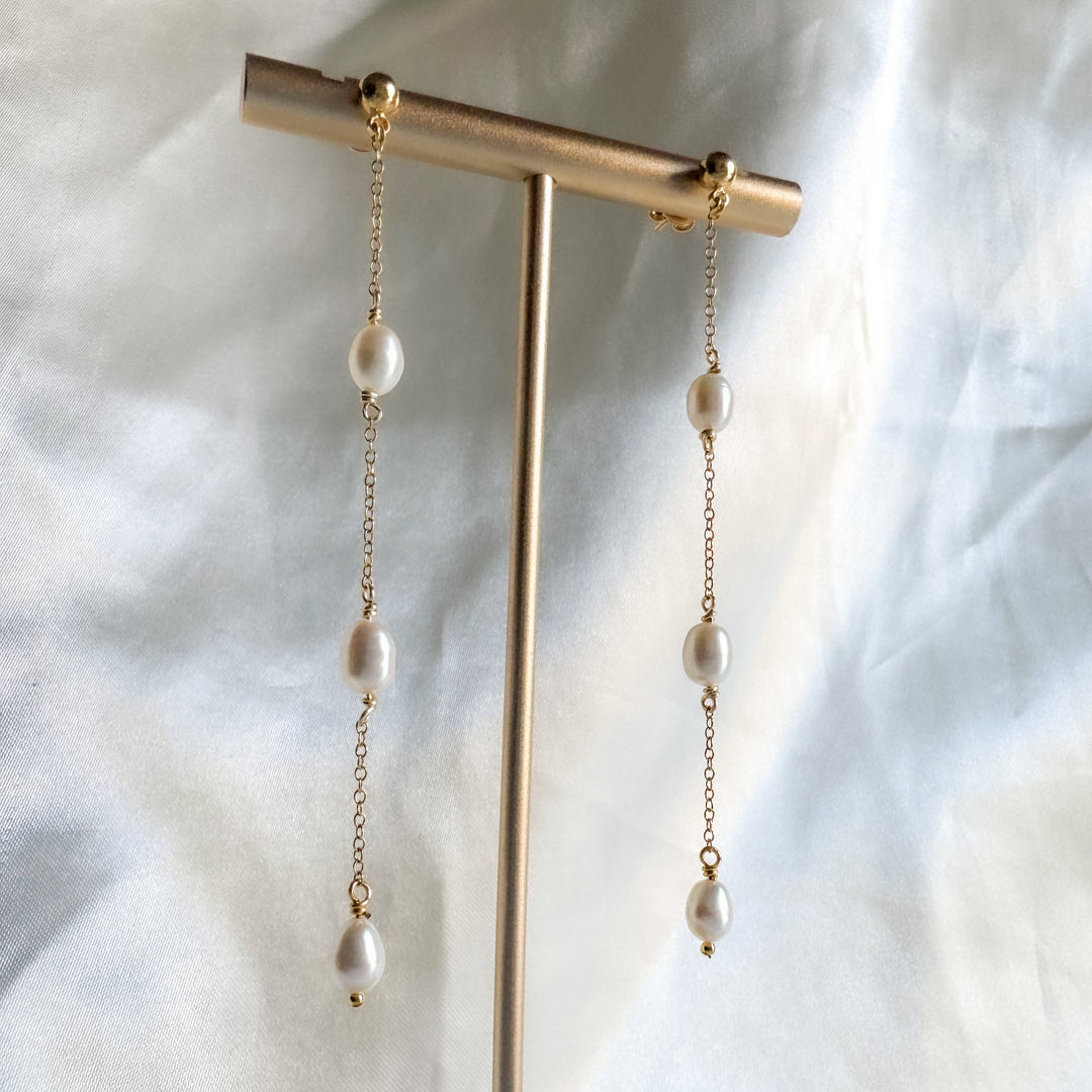 Freshwater pearl and gold filled chain earrings on display