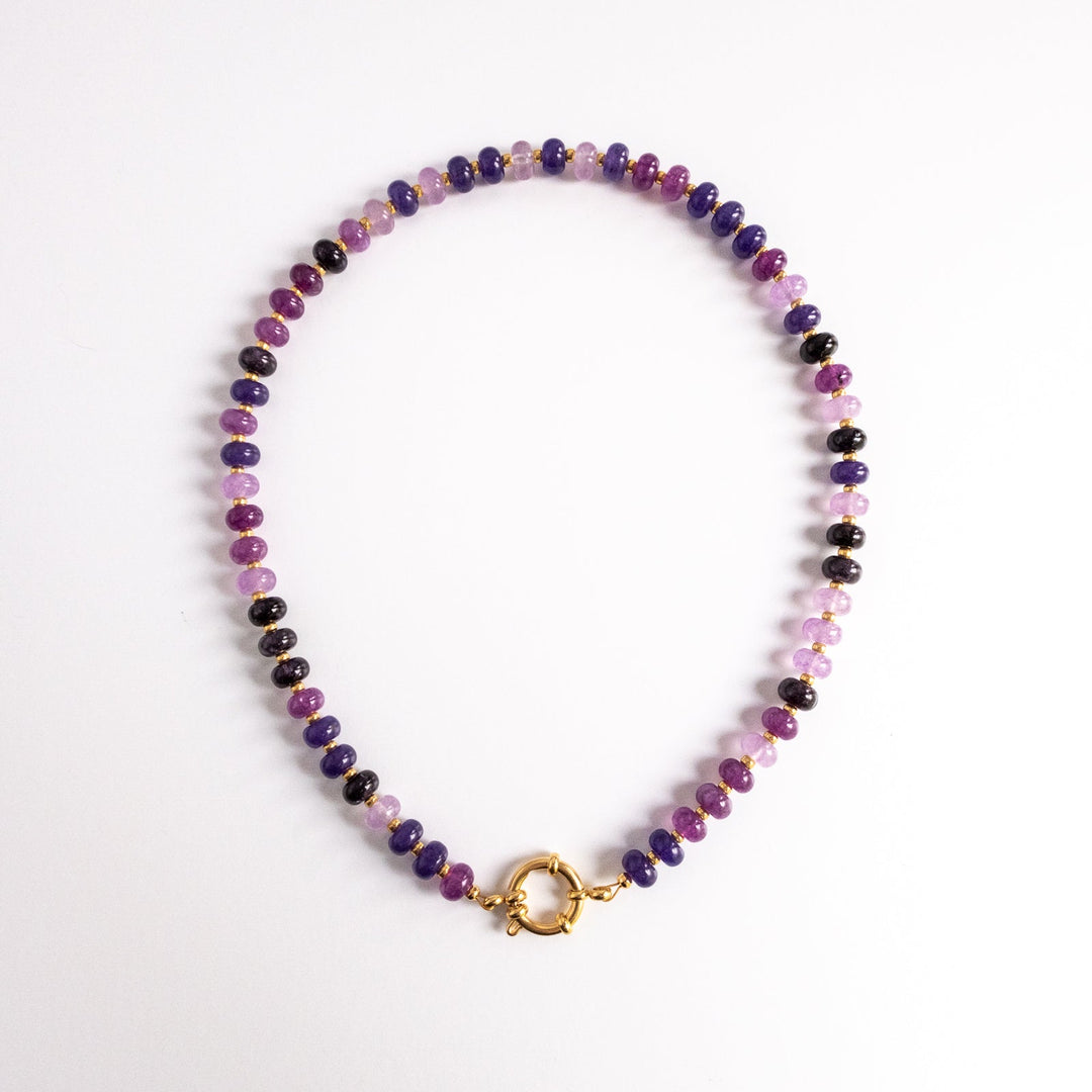 Multicolored beaded necklace with a gold clasp on a white background