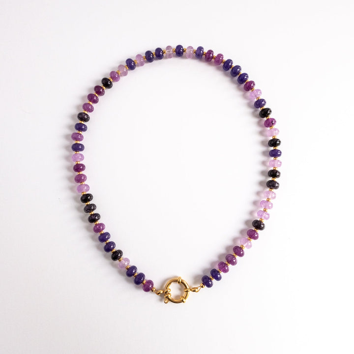 Multicolored beaded necklace with a gold clasp on a white background