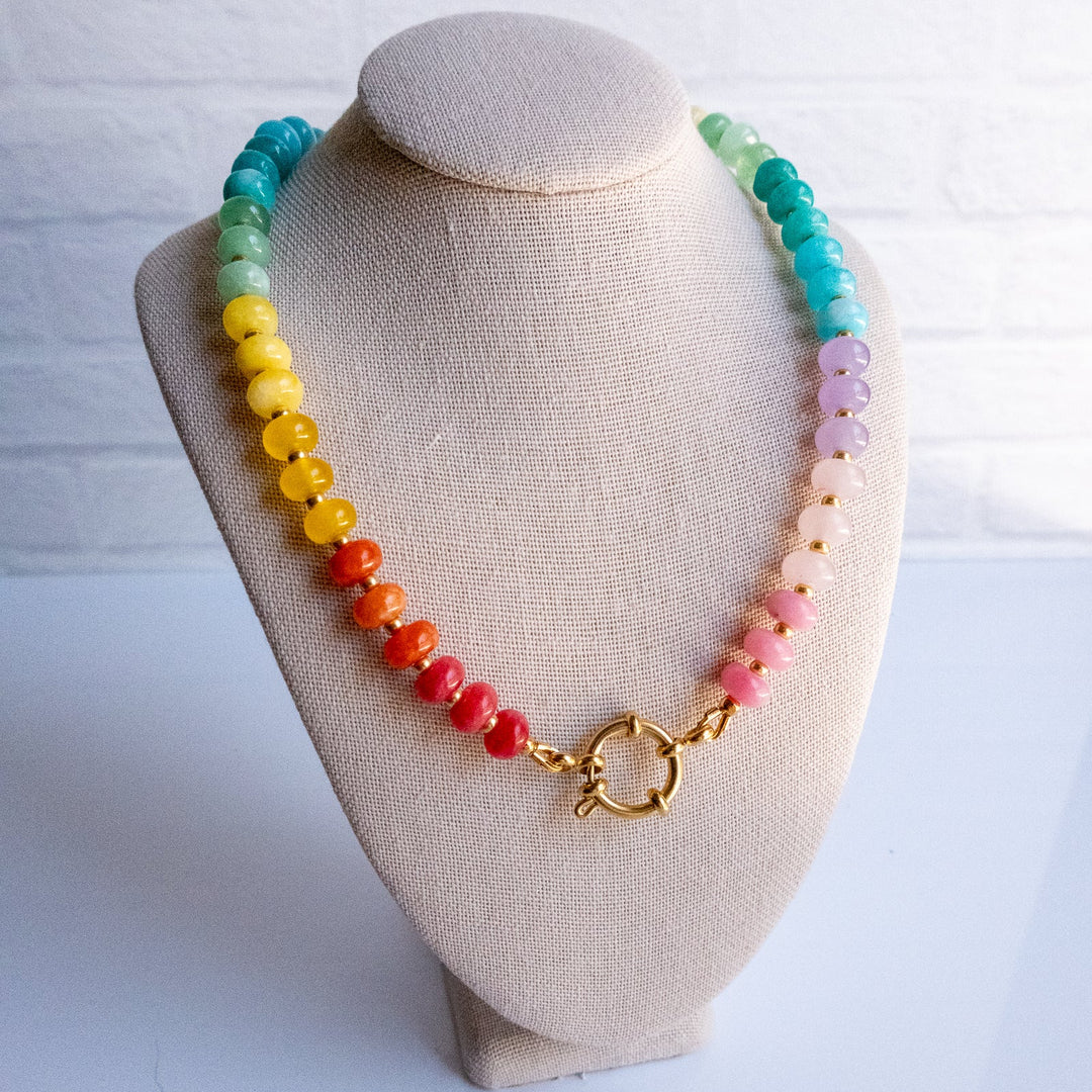 Colorful beaded necklace on a mannequin bust with a white background