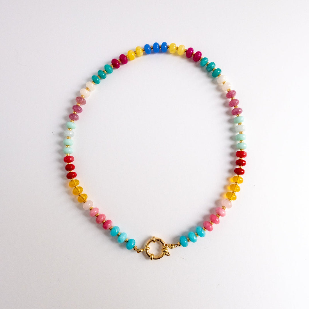 Colorful beaded necklace with a gold clasp on a light gray background