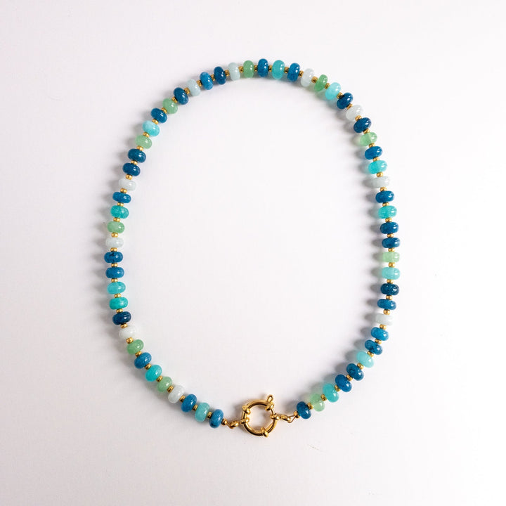 Beaded necklace with a gold clasp on a white background