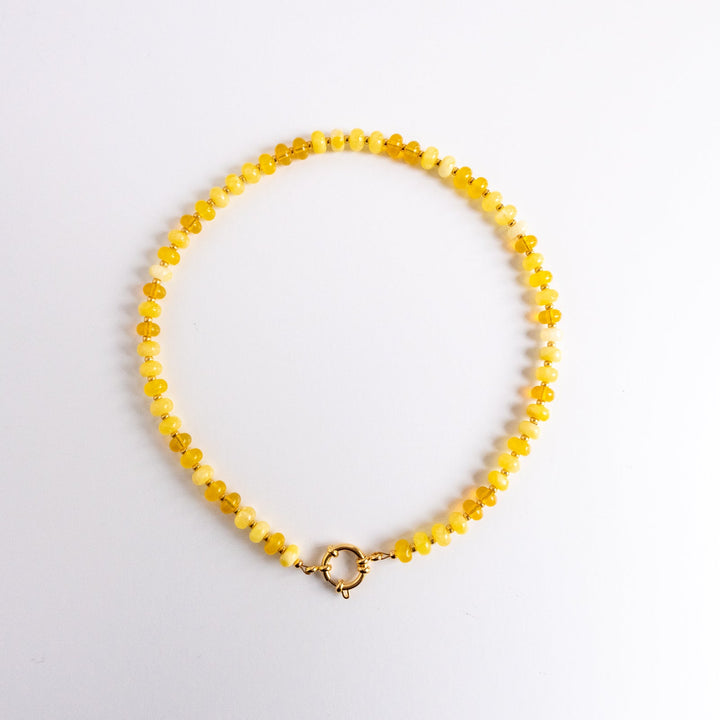 Yellow beaded necklace on a white background