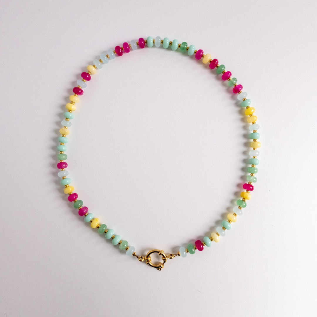 Colorful beaded necklace on a light gray background