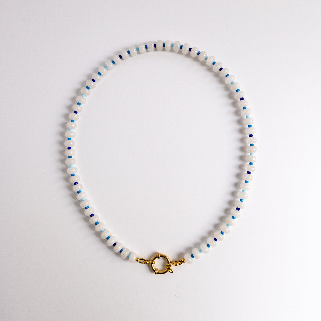 Beaded necklace with a gold clasp on a white background