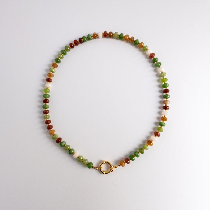 Beaded necklace with a gold clasp on a white background