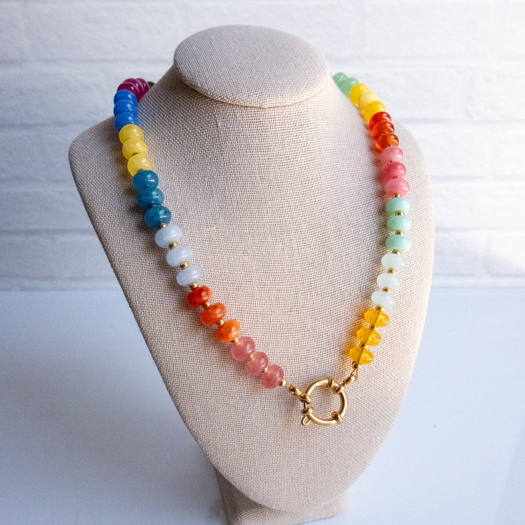 Colorful beaded necklace on a beige bust against a white background