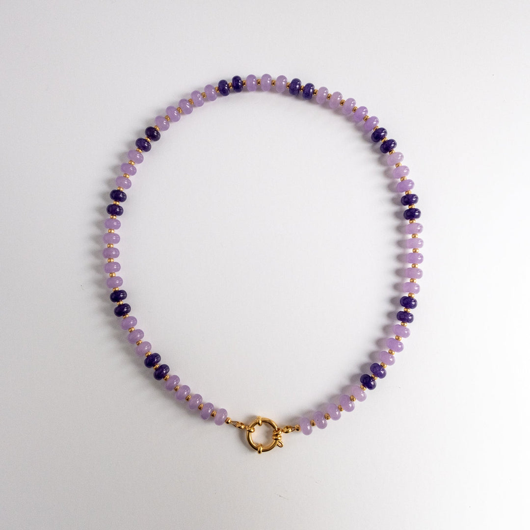 Beaded necklace with a gold clasp on a white background
