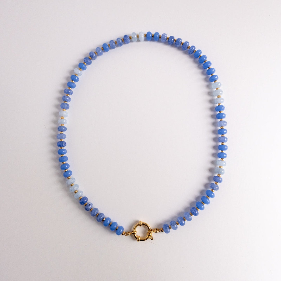 Necklace with blue and gray beads on a white background